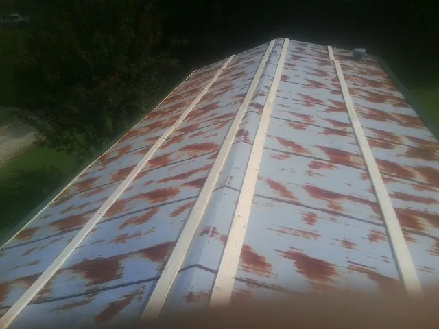 Rusted metal roof panels with new wood purlins before replacement — Storm Damage Roof Repair in Bergenfield by Roofing Brothers